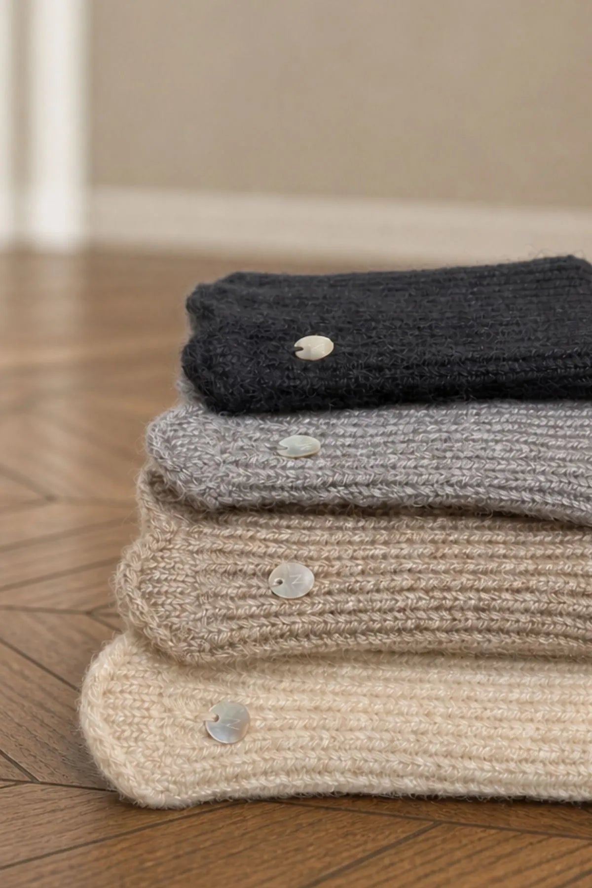 Mitaines 4 coloris : noir, gris, taupe et ecru, avec la pastille de coquillage signature Nathael Paris
